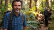 © JO BLA CO - A group of friends enjoys a day of hiking in a lush forest. The sun filters through the trees as they connect with nature and each other, surrounded by greenery and tranquility