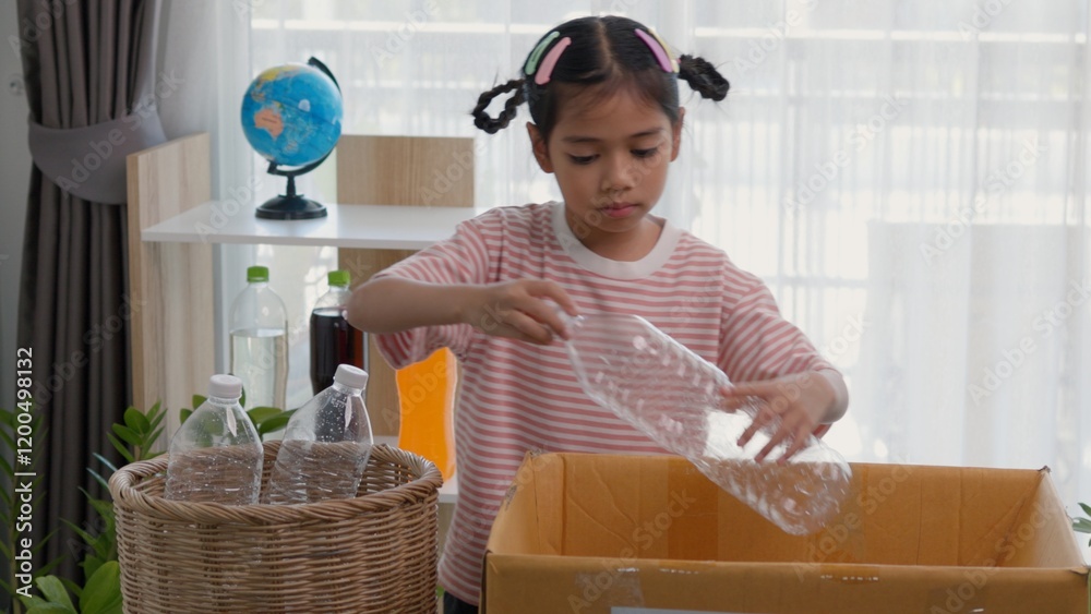 Foto de Stock Asian little Girls dump plastic bottles in recycling ...