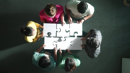 Sticker - Top view of business people separated jigsaw together at meeting. Aerial view of diverse team put piece of jigsaw puzzle together out and standing while wearing casual cloth at conference. Symposium.