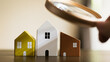 © sommart - Hand holding magnifying glass and looking at house model, house selection, real estate concept.
