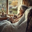 © milkyway - Elderly Woman Relaxing with Contented Cat in Cozy Armchair by Peaceful Window