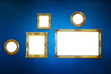 Wall Mural - Golden picture frames on blue wall