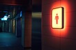 © Sean Hoong - A glowing public restroom lightbox sign mounted on the entrance wall, directing visitors.