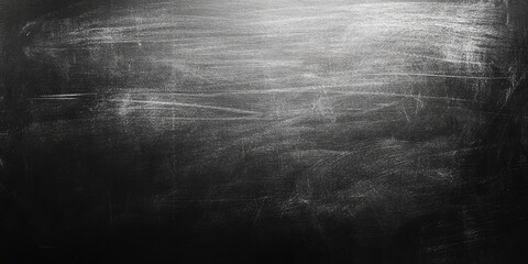 Grunge blackboard background with uneven white chalk texture featuring ample copy space for text with dark charcoal tones and light white streaks