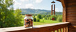 © Anastasiya - Beads in a jar on wooden balcony ledge, serene rural landscape