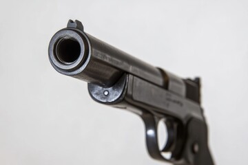 Poster - A close-up view of a gun on a white background, suitable for editorial use