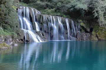 Poster - A waterfall flowing down a hillside, great for outdoor and nature scenes
