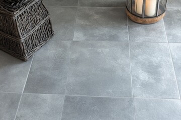 Aufkleber - A single candle sits atop a tiled floor, providing warm light