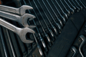 Poster - Close-up of metal wrenches organized in a tool tray, showcasing sizes and textures, ideal for automotive repair and maintenance work