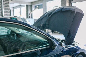 Poster - Blue car with an open hood in a garage. Concept for automotive diagnostics, repair, and service in a professional workshop environment