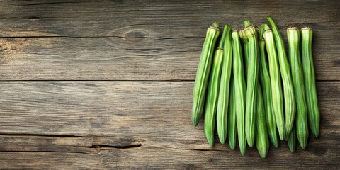 Poster - Fresh bunch of lady fingers or okra displayed on a rustic wooden background, highlighting the vibrant green color and unique texture of the lady fingers or okra for culinary purposes.