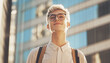© Soloviova Liudmyla - Portrait of modern  positive young man in glasses with confident pose, simple city street background, strong posture, and self-assured expression