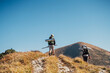 © Soloviova Liudmyla - Boy with mom backpackers walking by rocky Slovakian Mala Fatra mountain range with backpacks and tracking poles. Active lifestyle and family relations concept image in wild outdoor