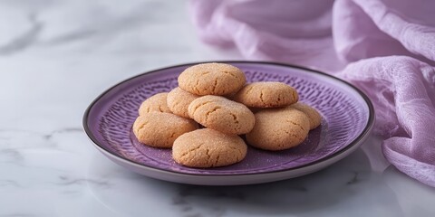 Poster - Delicious dry cookies beautifully presented on a purple plate, wrapped in mica for added elegance. The contrast of the dry cookies against the white background enhances their appeal.