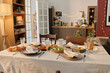 © AnnaStills - Wide shot of table covered with cotton tablecloth and served with delicious homemade food