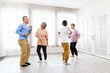 © artitwpd - Active Asian senior group mix with man and woman exercise by dancing together at home with relaxing, smiling and laughing. Indoor activity for mature seniors and retirement people.