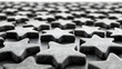 © Putu - Abstract monochrome close-up of numerous star-shaped objects, creating a textured, repeating pattern. Ideal for concepts related to rating, ranking, or achievement.
