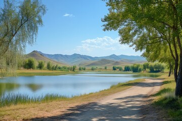 Wall Mural - Dirt road running along picturesque lake with mountains in background