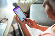 © Marko Geber - Senior woman managing online account on smartphone at home