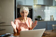 © Marko Geber - Senior woman working on laptop at home