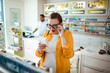© Davor - Pregnant woman reading products in pharmacy
