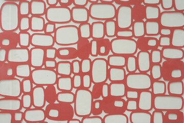 decorative die-cut overlay pattern inside plastic sheet on blank paper