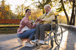 © New Africa - Caregiver with elderly woman in wheelchair at park