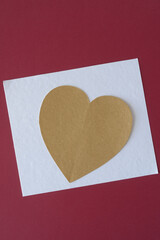 Wall Mural - large gold paper heart on white and red