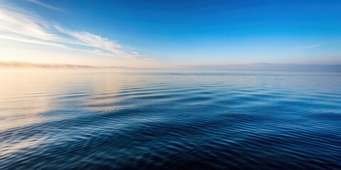 Wall Mural - Gentle sea ripples on a calm ocean surface with morning fog rolling in softly , landscape, fog,  landscape, fog, ocean, serene
