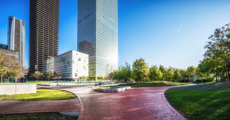 Fototapete - Serene Urban Park with Modern Skyscraper Silhouettes