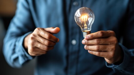 Poster - Man holding light bulb in hands symbolizing ideas and innovation concept