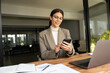 © Stock 4 You - Focused Latin Hispanic female businesswoman holding smartphone sitting at desk in office. Successful middle age business woman manager ceo using cell phone mobile pc for online working. Copy space