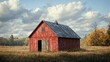 © 3DLeonardo - A weathered red barn sits in a field of tall grass under a partly cloudy sky.  Autumn trees are in the background.