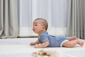 Wall Mural - Happy newborn baby on comfortable play mat