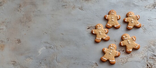 Poster - Gingerbread men cookies on a textured surface with Copy Space for text placement