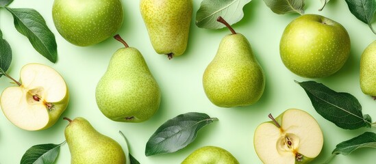 Poster - Fresh green pears and apple halves arranged on a light green background with leaves and ample Copy Space for text.