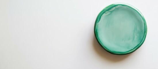 Poster - Green circular dish on a white background with ample Copy Space for text placement.