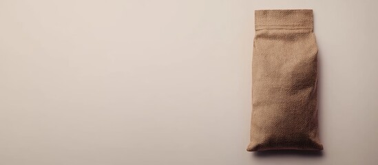 Aufkleber - Brown paper bag on a neutral background with copy space for text or branding.