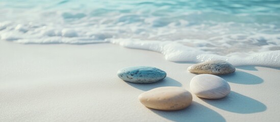 Poster - Smooth beach pebbles in shallow water with soft waves on sandy shore Copy Space