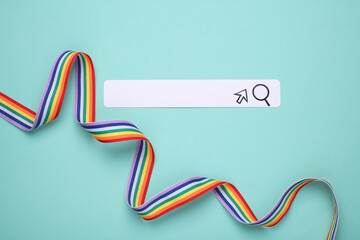 Paper search bar with cursor and lgbt rainbow ribbon on blue background.