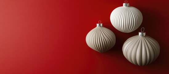 Poster - Three textured white Christmas ornaments hanging on a red background with ample copy space for text placement.
