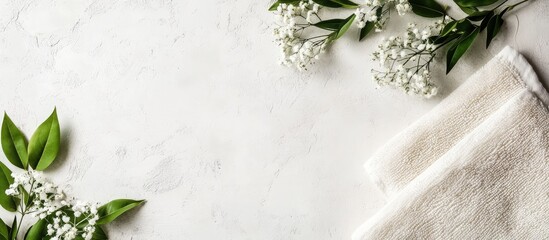 Leinwandbilder - White towels and fresh white flowers on a marble surface with copy space for text or design elements.
