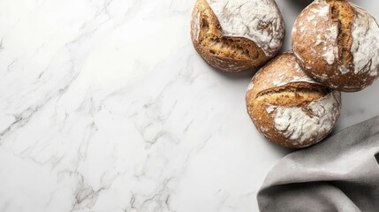 Poster - Freshly baked artisan bread loaves on marble countertop with gray linen napkin and ample copy space for text