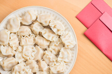 Wall Mural - Traditional Chinese dumplings with red packet decoration