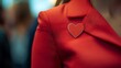 © Tobi - Confident professional in vibrant red attire showcasing a heart-shaped name badge during a corporate event