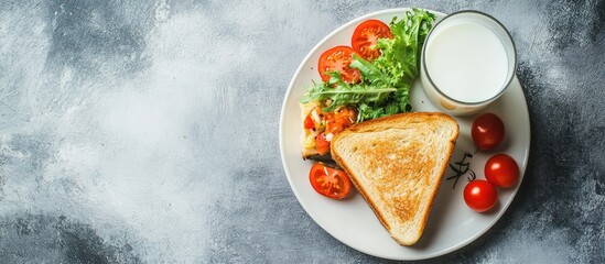 Poster - Breakfast plate with toasted bread, fresh tomatoes, leafy greens, and a glass of milk on a textured grey background Copy Space