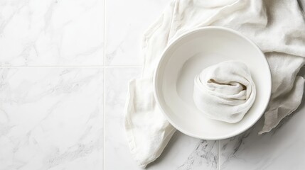 Poster - Minimalistic kitchen setting with white bowl and linen cloth on marble surface featuring ample copy space.
