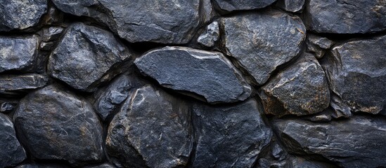 Fototapete - Textured dark stone wall background with variations in shape and color, suitable for design projects, Copy Space available.