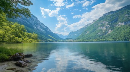 Fototapete - Scenic mountain landscape with calm lake and trees under a blue sky with clouds Copy Space