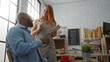 © Krakenimages.com - Woman waitress taking order from man customer inside cozy bakery with bread display and menu board in the background